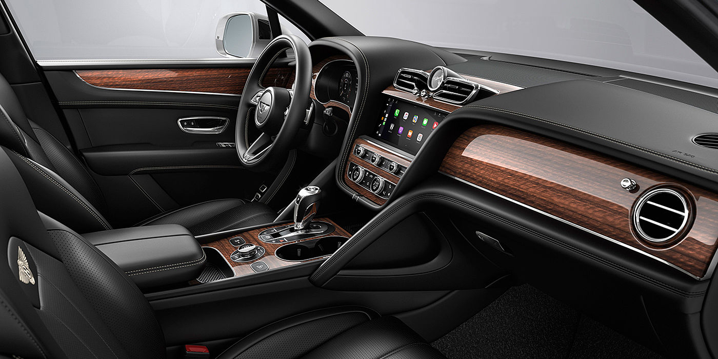 Bentley Riyadh Bentley Bentayga interior with a Crown Cut Walnut veneer, view from the passenger seat over looking the driver's seat.