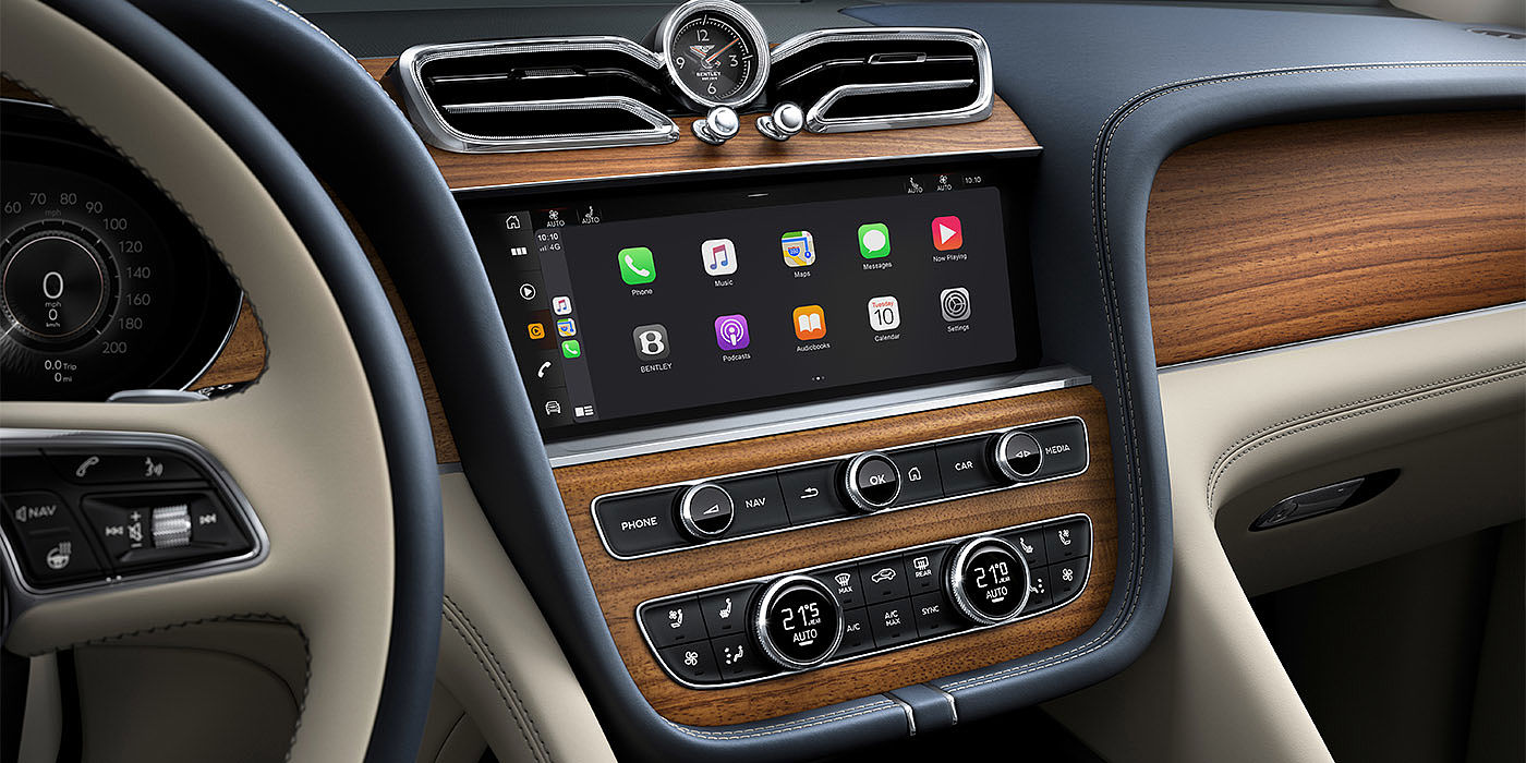 Bentley Riyadh Bentley Bentayga EWB Azure dashboard in Open Pore Koa veneer featuring multimedia screen and climate control console.