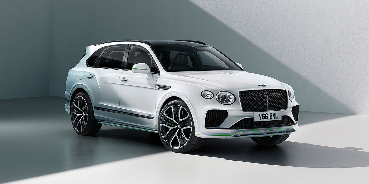 Bentley Riyadh Bentley Bentayga Speed SUV front three quarter in Snow Quartz Pearlescent by Mulliner white paint against a grey wall