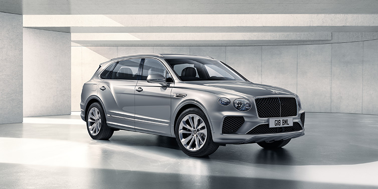 Bentley Riyadh Bentley Bentayga Extended Wheelbase SUV front three quarter in Moonbeam paint with a grey background