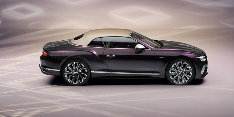 Bentley Riyadh Bentley Continental GTC Mulliner convertible in profile with hood up, in Tanzanite Purple paint and 22 inch Mulliner painted and polished wheels