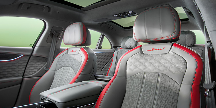 Bentley Riyadh Bentley Flying Spur Speed sedan interior showing front and rear seats in Hotspur red and Gravity Grey hides, with Speed seat emblems