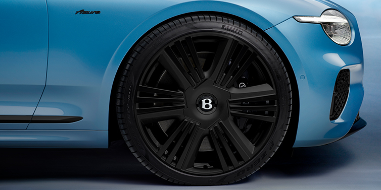Bentley Riyadh New Bentley Continental GTC Azure convertible front wheel detail with 22 inch black ten spoke wheel and dark chrome details against Light Windsor blue paint
