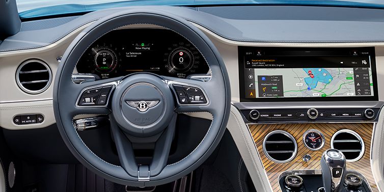 Bentley Riyadh New Bentley Continental GT Azure coupe front interior in Linen and Brunel blue hides, showing steering wheel and driver's instruments