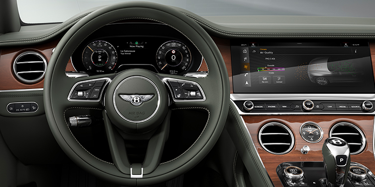 Bentley Riyadh New Bentley Continental GT coupe steering wheel and front cabin view in Cumbrian Green hide and Crown Cut walnut veneer